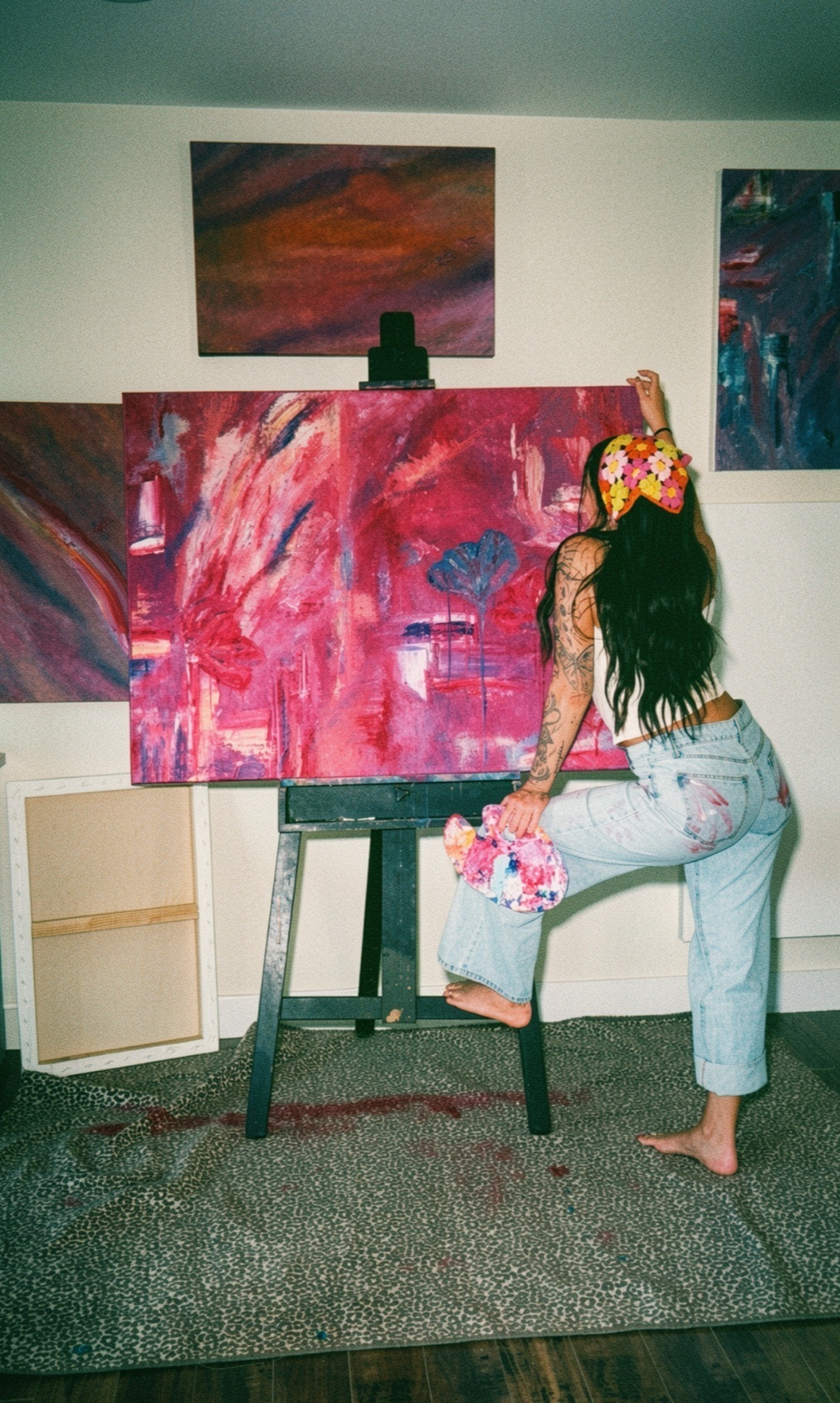 Huntress at the easel, reaching into a piece in progress
