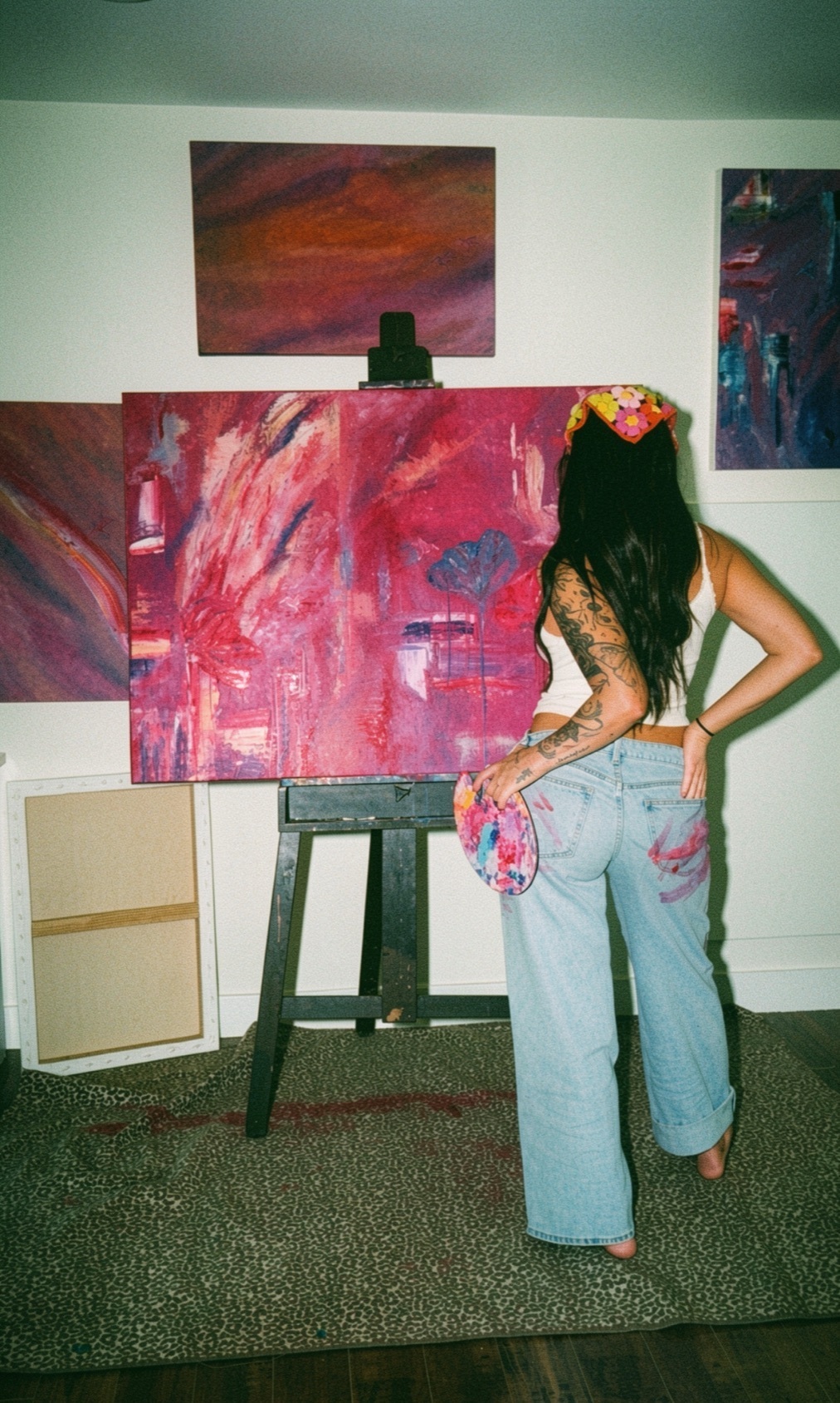 Huntress in the studio, palette in hand before her canvas